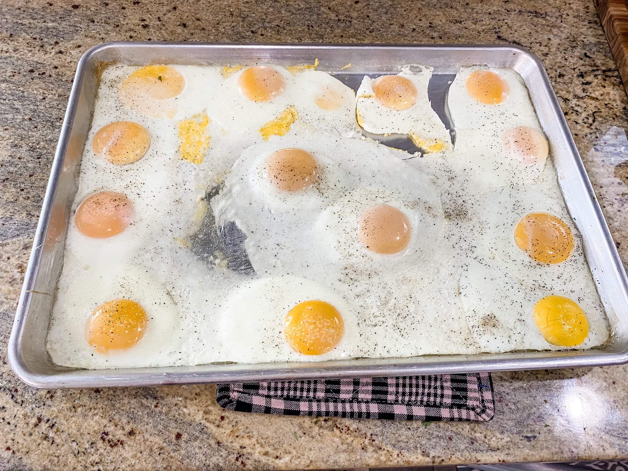 baked eggs on a sheet pan with set whites