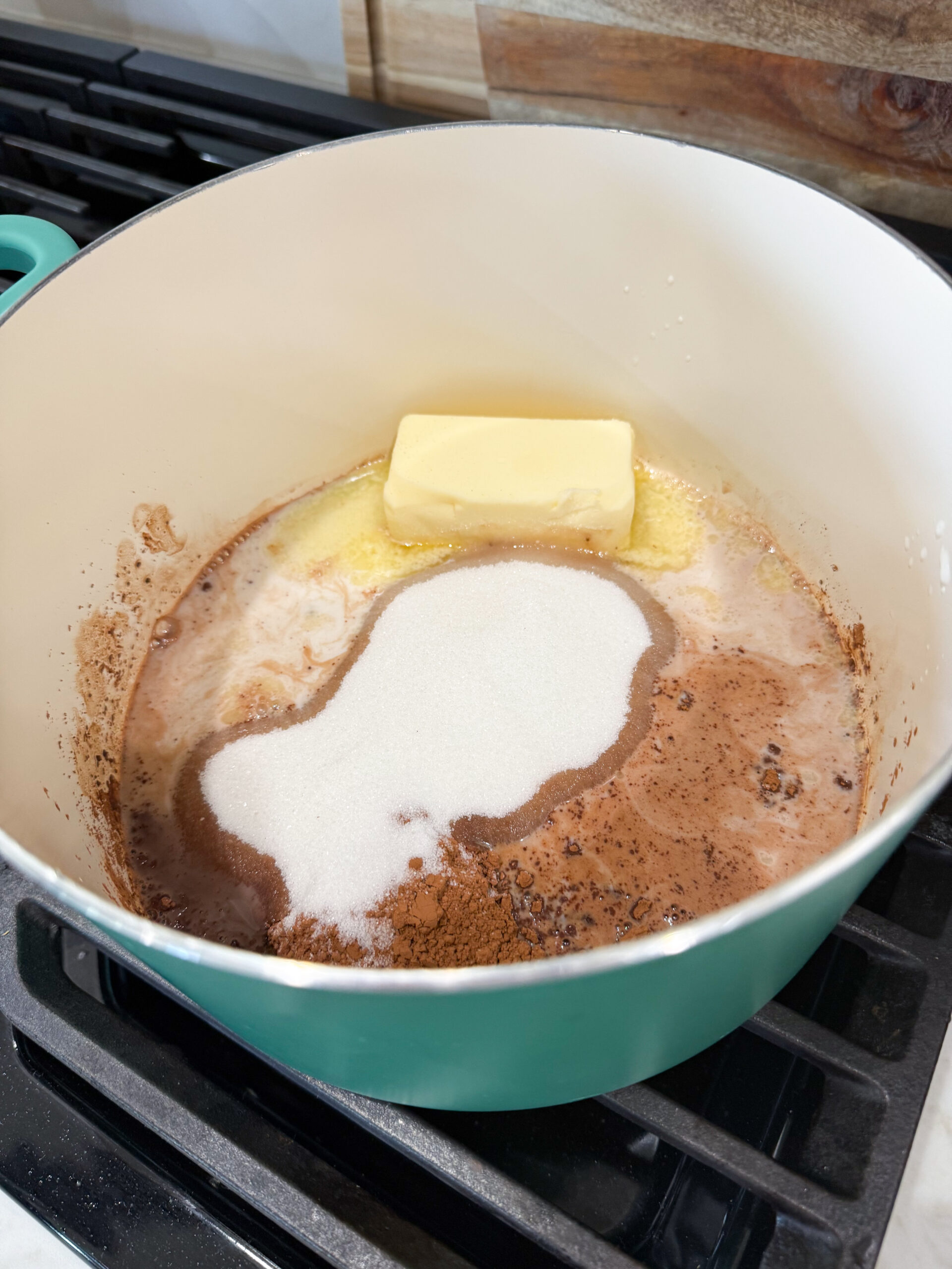 Sugar, milk, butter, and cocoa powder in a pot
