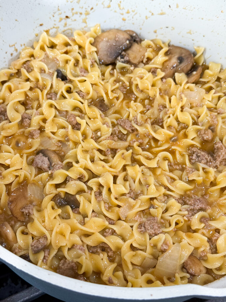 cooked turkey and egg noodles in a large skillet