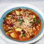 Slow cooker minestrone soup in bowl with Parmesan