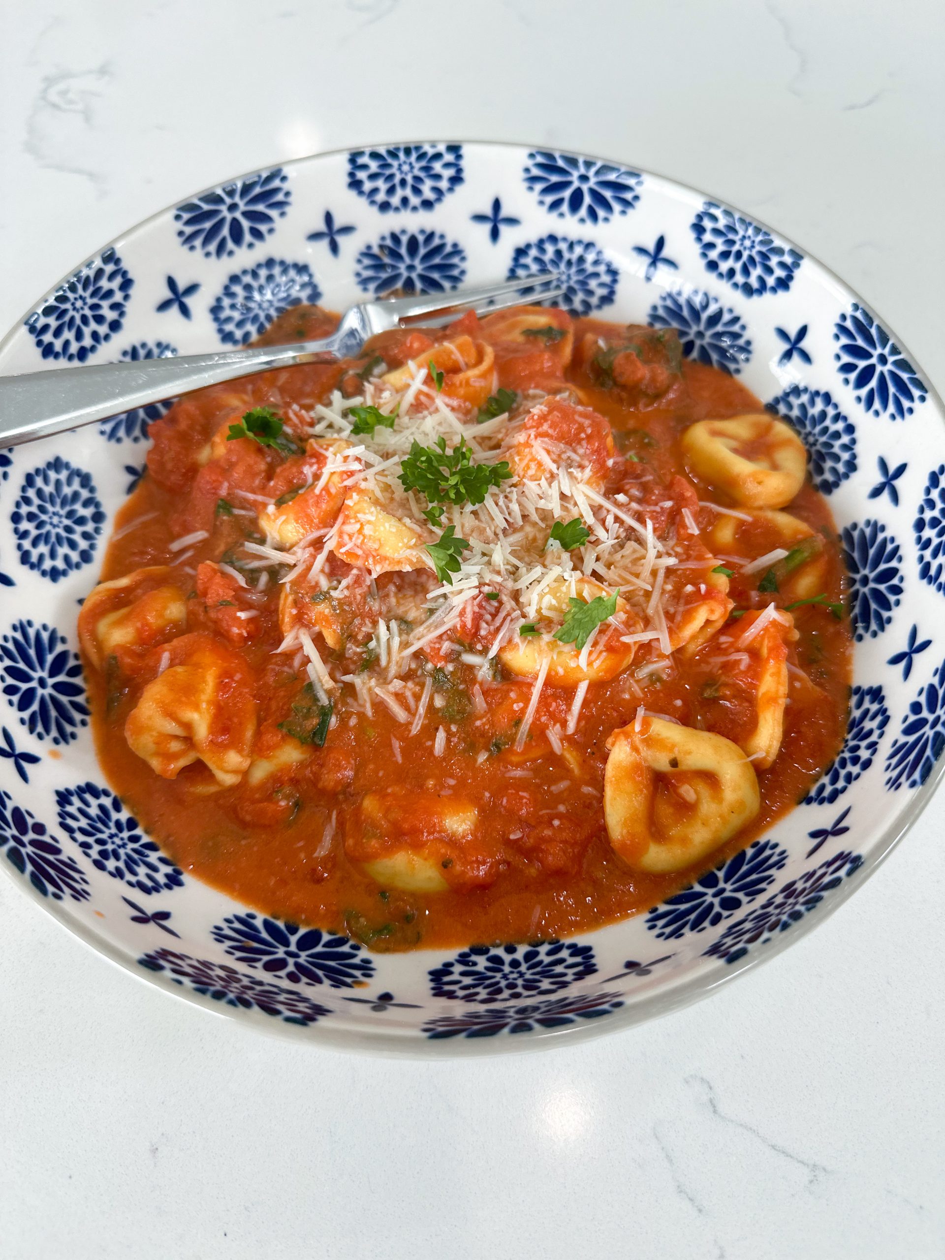 skillet tortellini with spinach and parmesan in a creamy tomato sauce