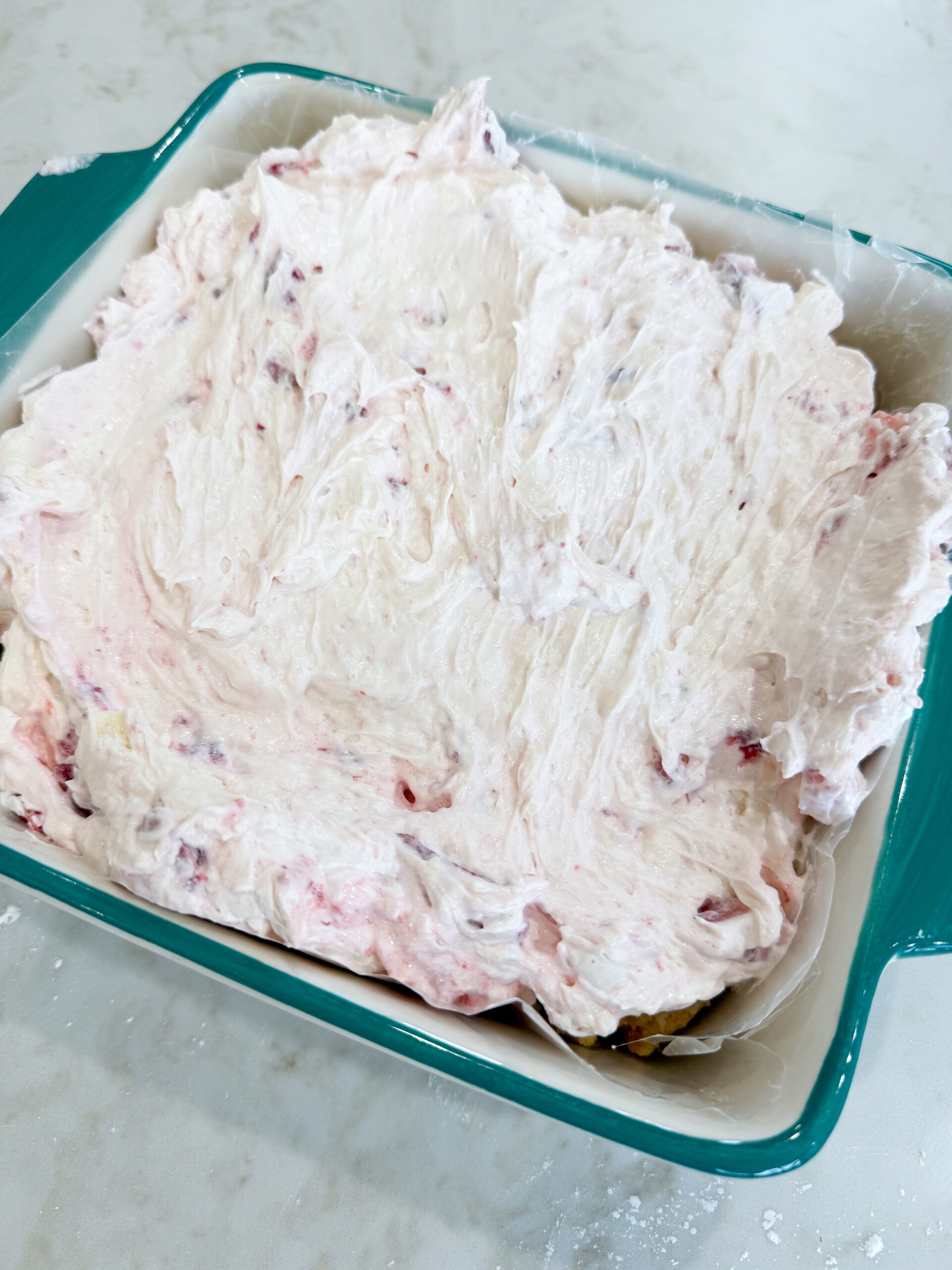 Strawberry cheesecake mixture spread over the crust
