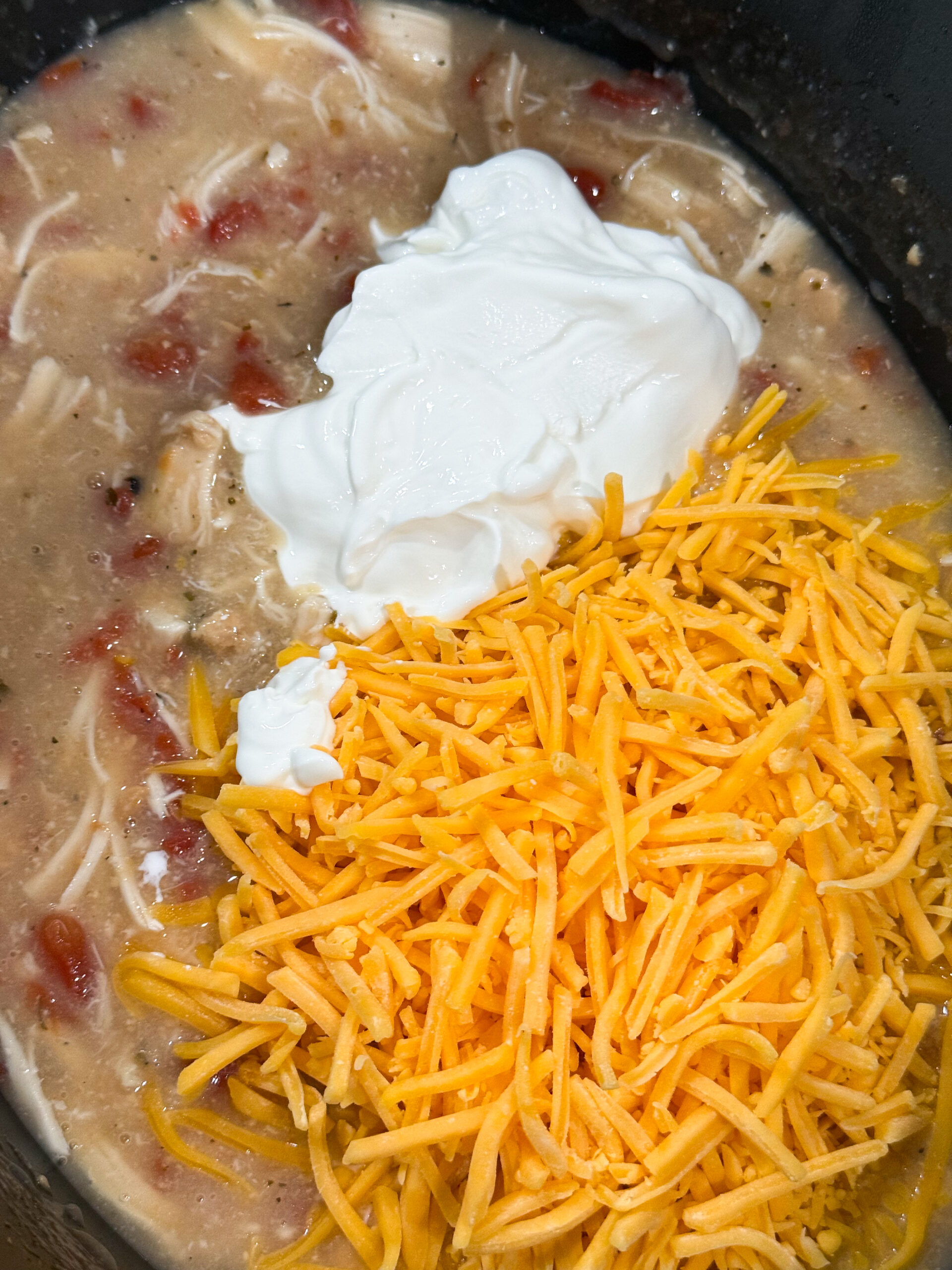 Cheese and sour cream added to slow cooker