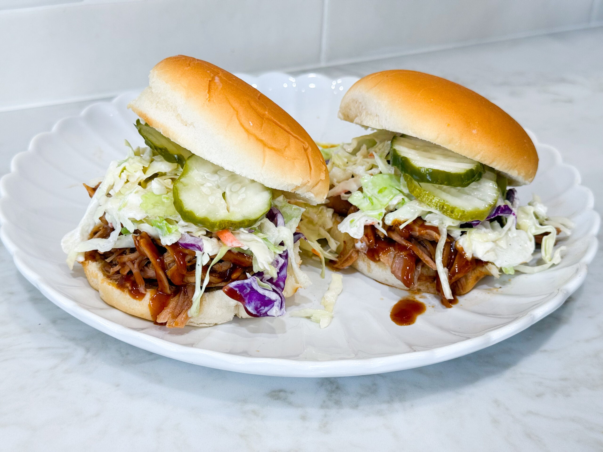 shredded barbecue pulled pork piled on hamburger buns