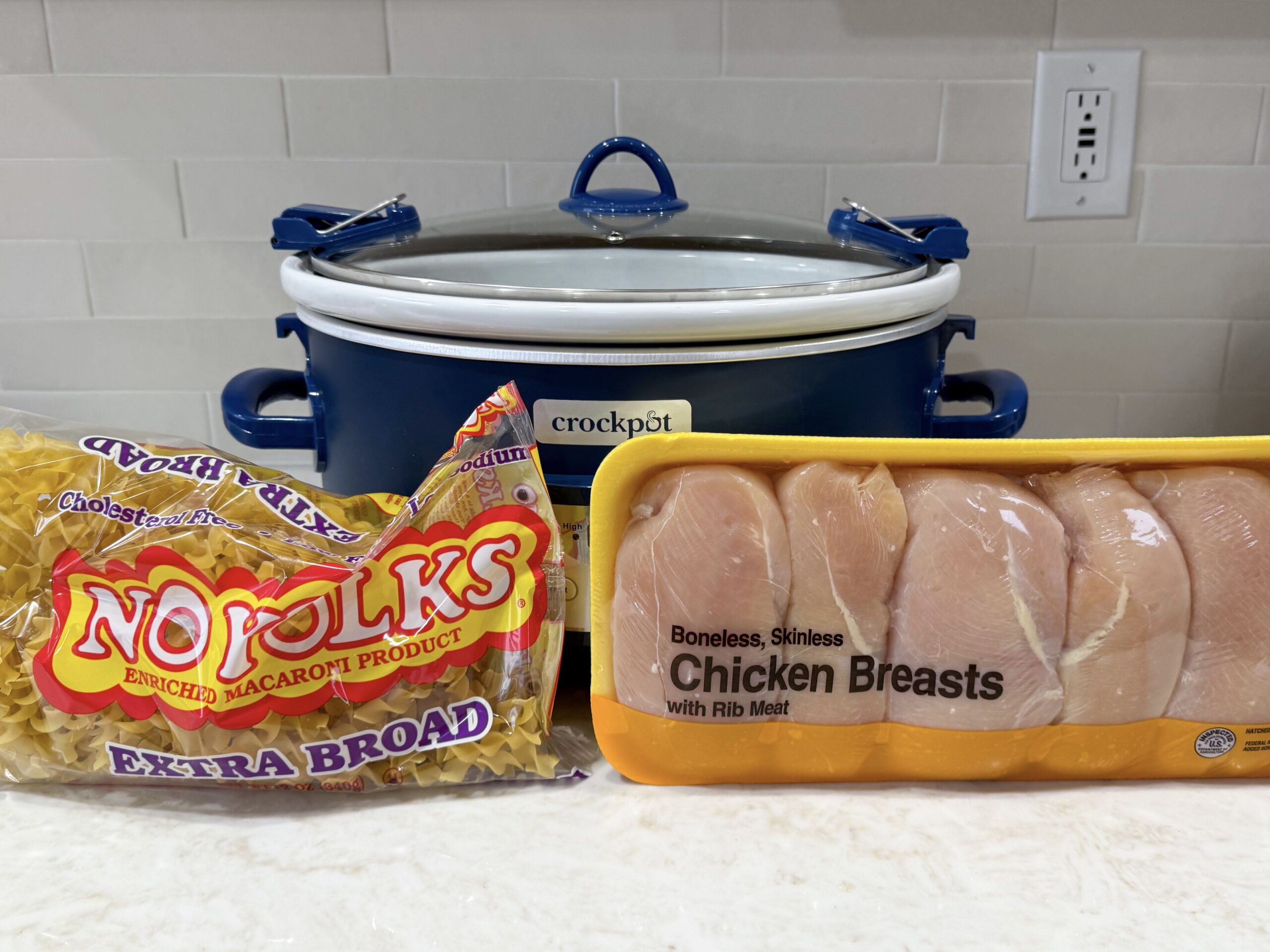Ingredients for chicken noodle pasta on the counter