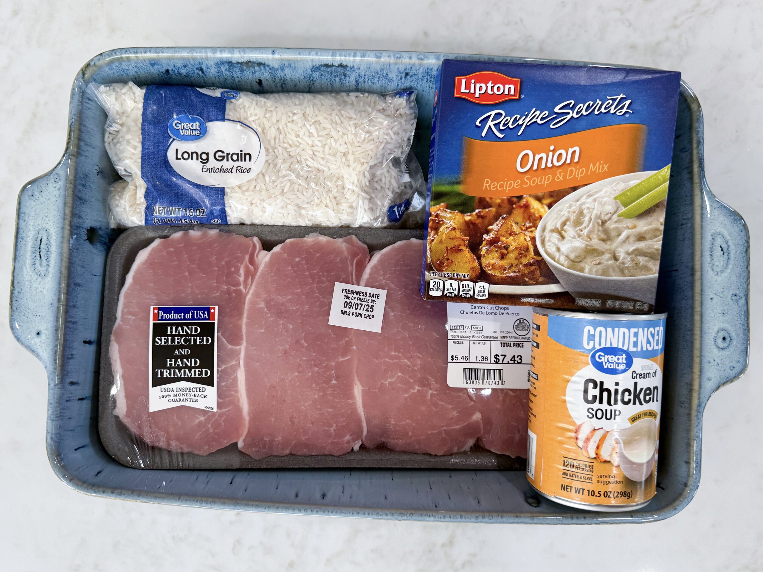 Ingredients for No Peek Pork Chop Casserole including pork chops, jasmine rice, cream soups, broth, and onion soup mix.