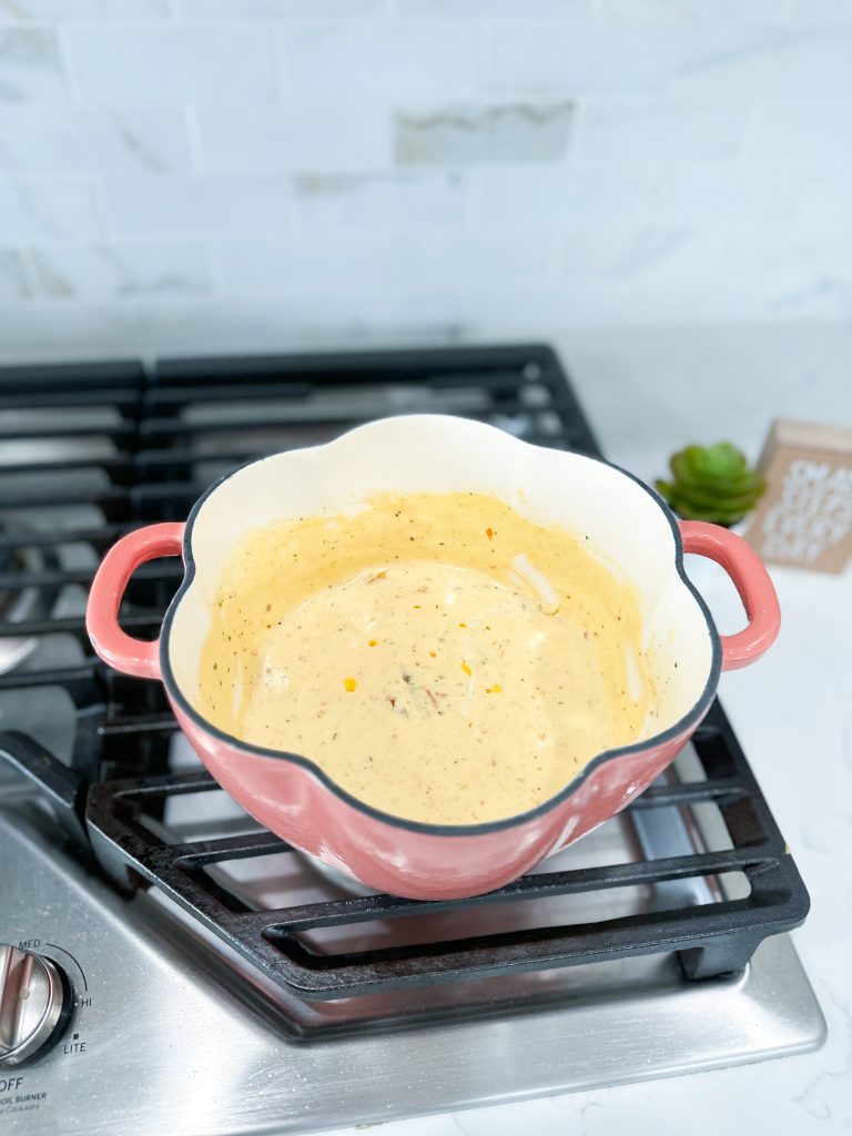 Cream, sun dried tomato, Parmesan, and remaining seasonings to a saucepan.