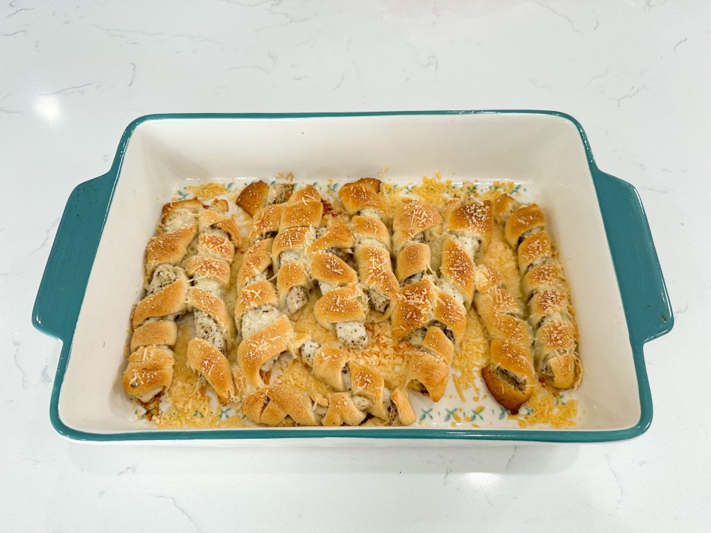 Golden baked chicken wrapped in crescent dough, drizzled with creamy sun-dried tomato sauce