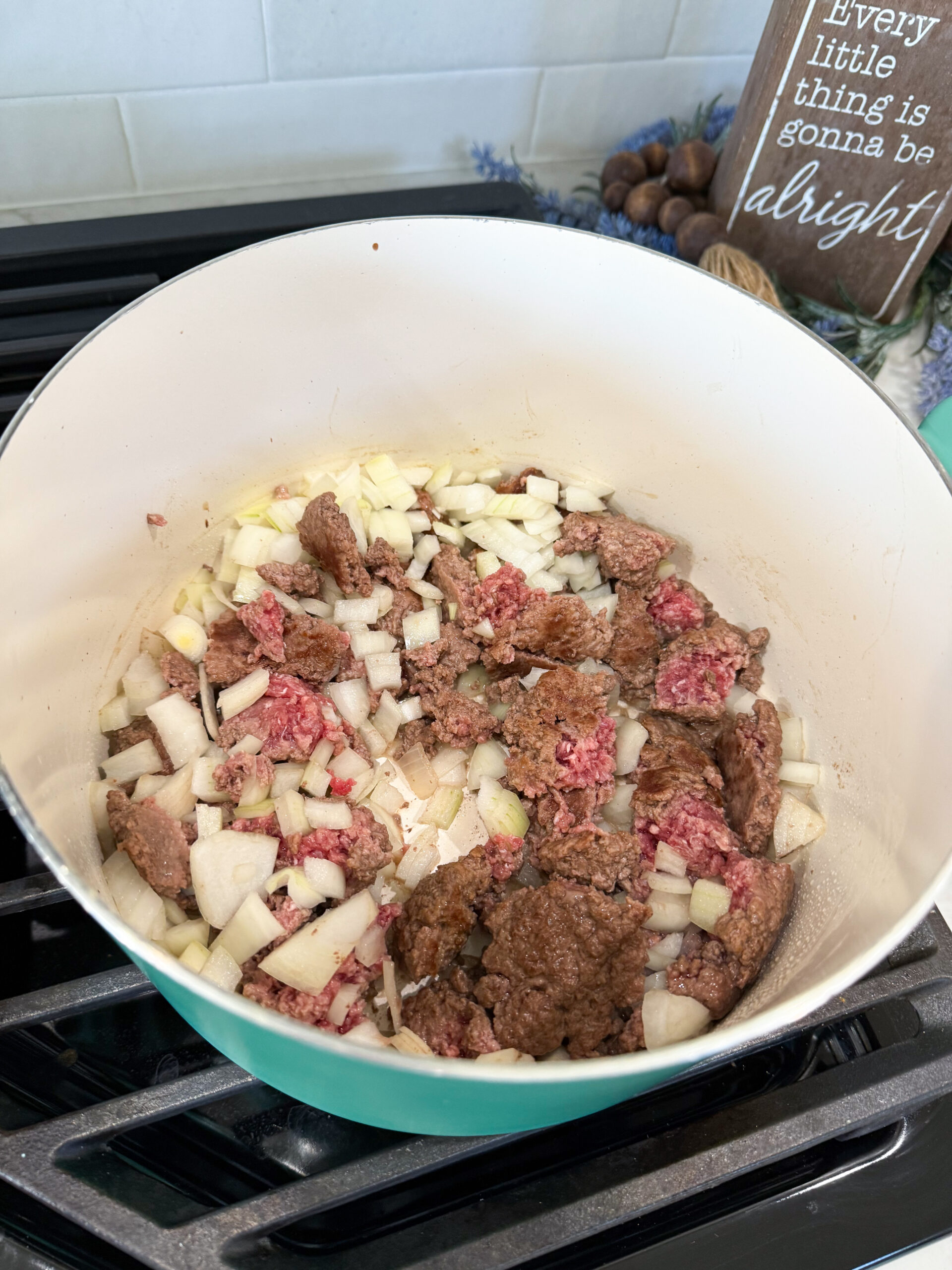 Ground beef cooking in a large pot