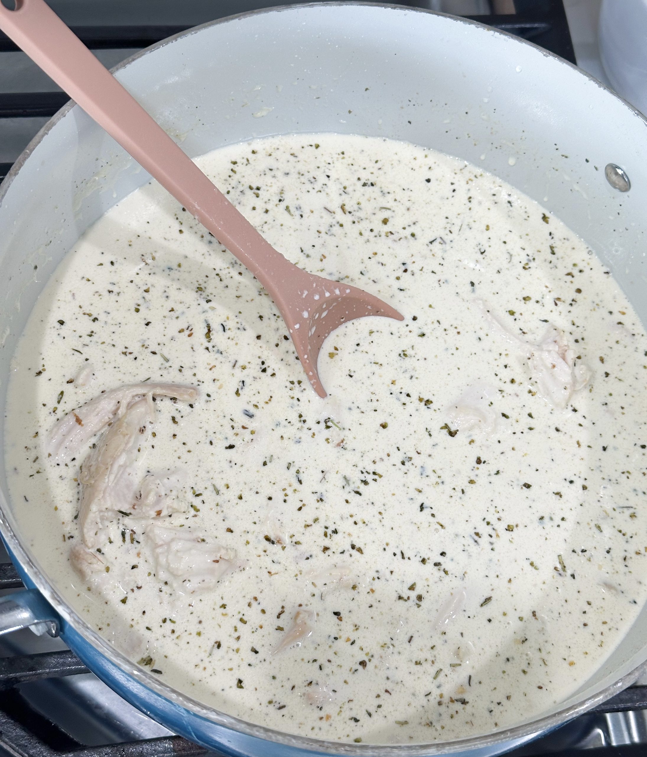 cream and chicken simmering in skillet