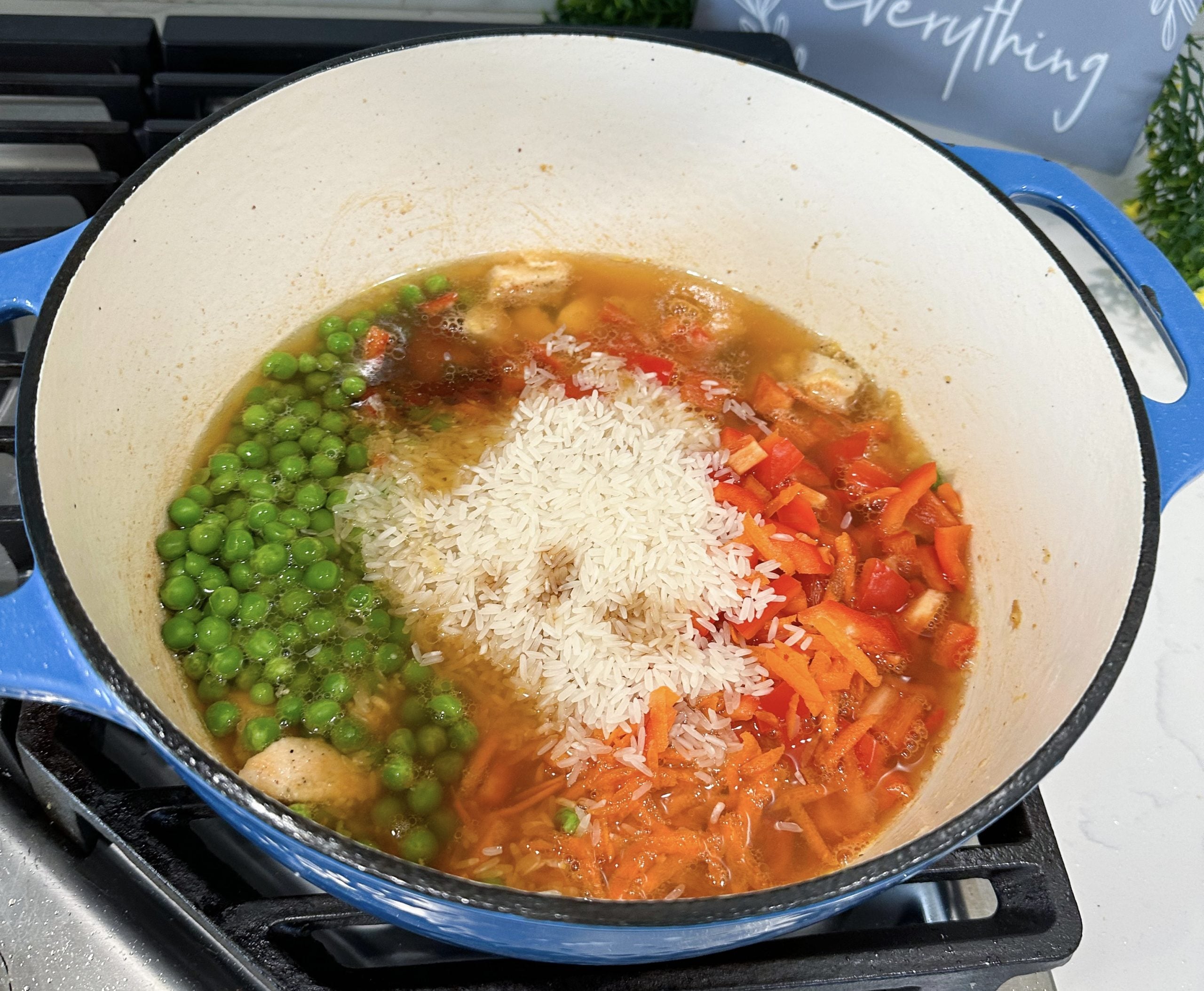 bell pepper, carrots, broth, rice, soy sauce, and honey added to the pot