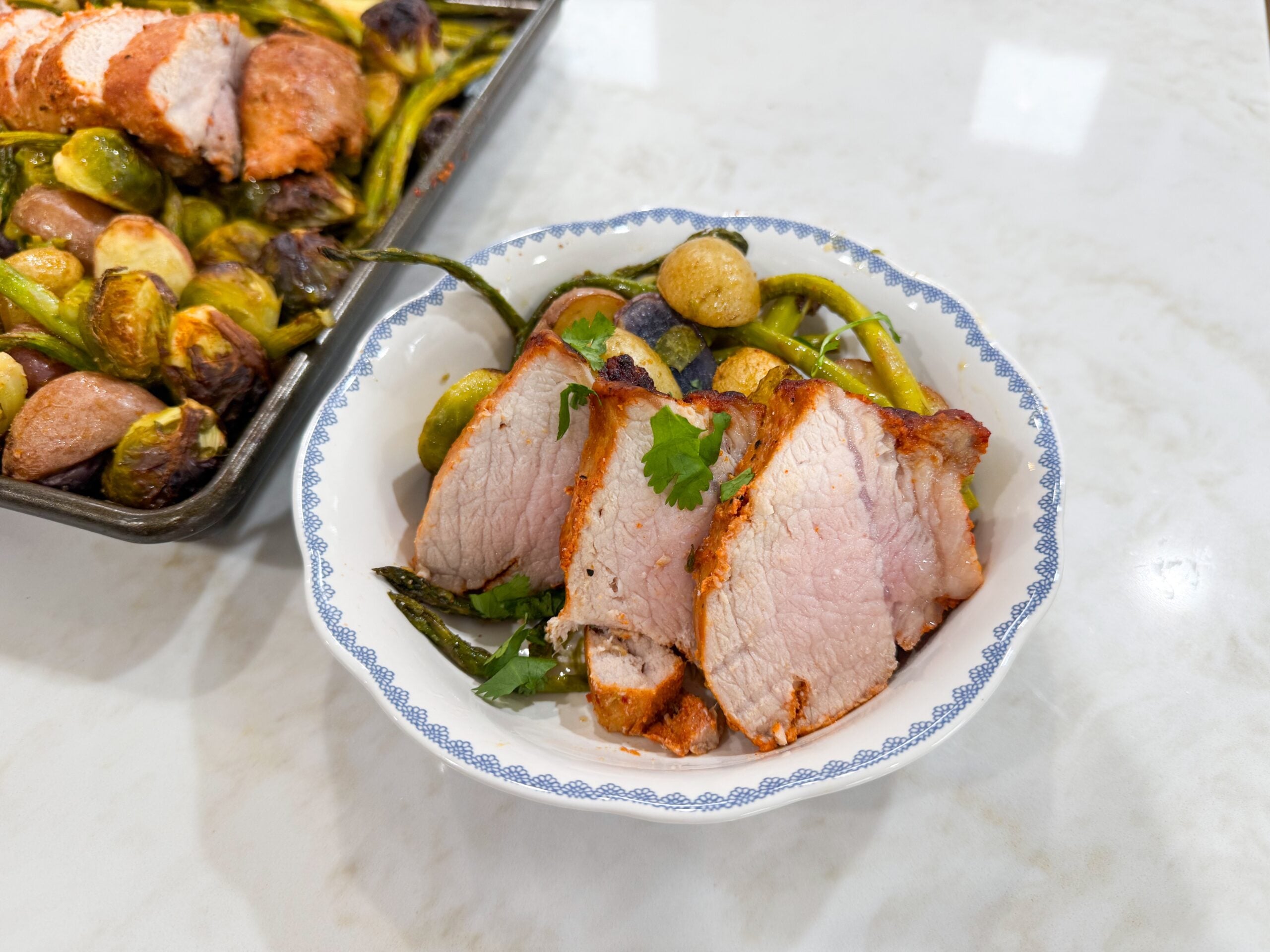 pork tenderloin plated with vegetables in a bowl
