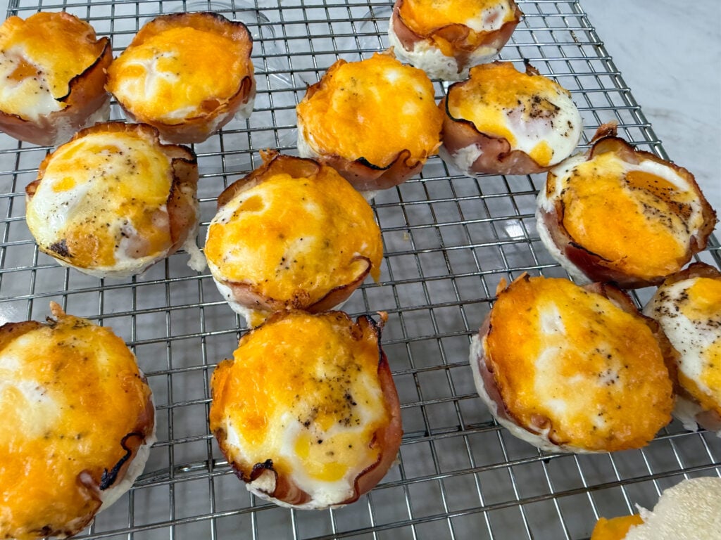Cooked Ham and Eggs bites on a cooling rack.