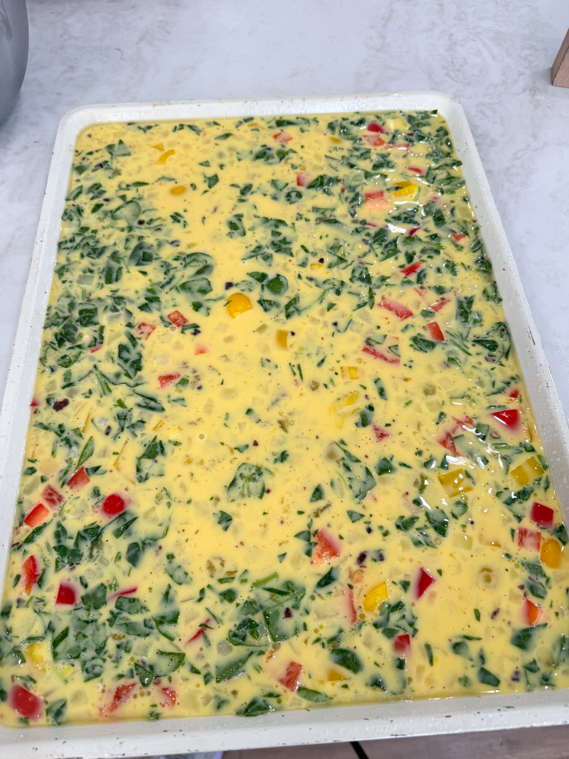 Sheet pan with cooked scrambled eggs.