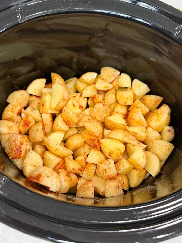 Diced seasoned potatoes in a slow cooker
