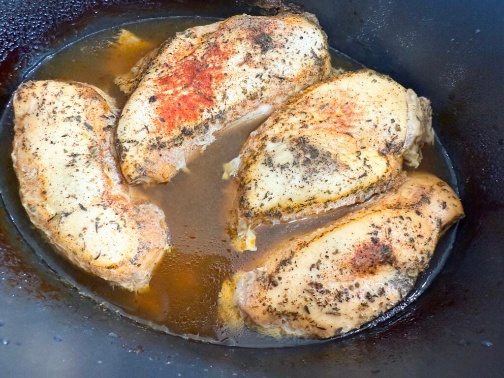 cooked seasoned chicken in a slow cooker