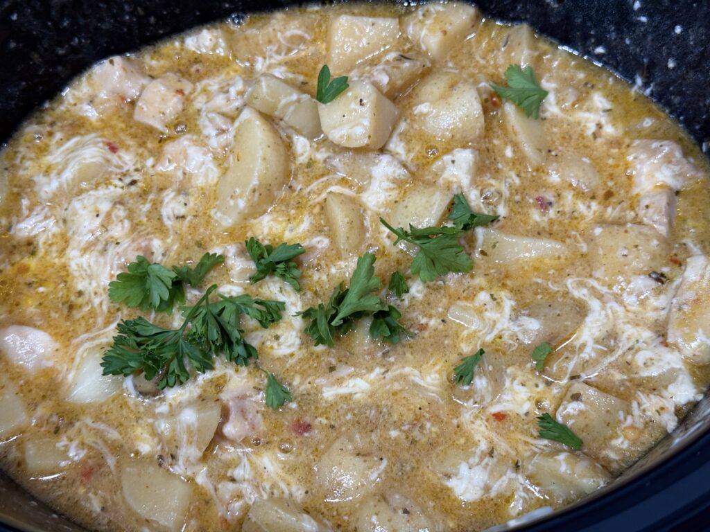 creamy parmesan sauce with cooked chicken and fresh parsley