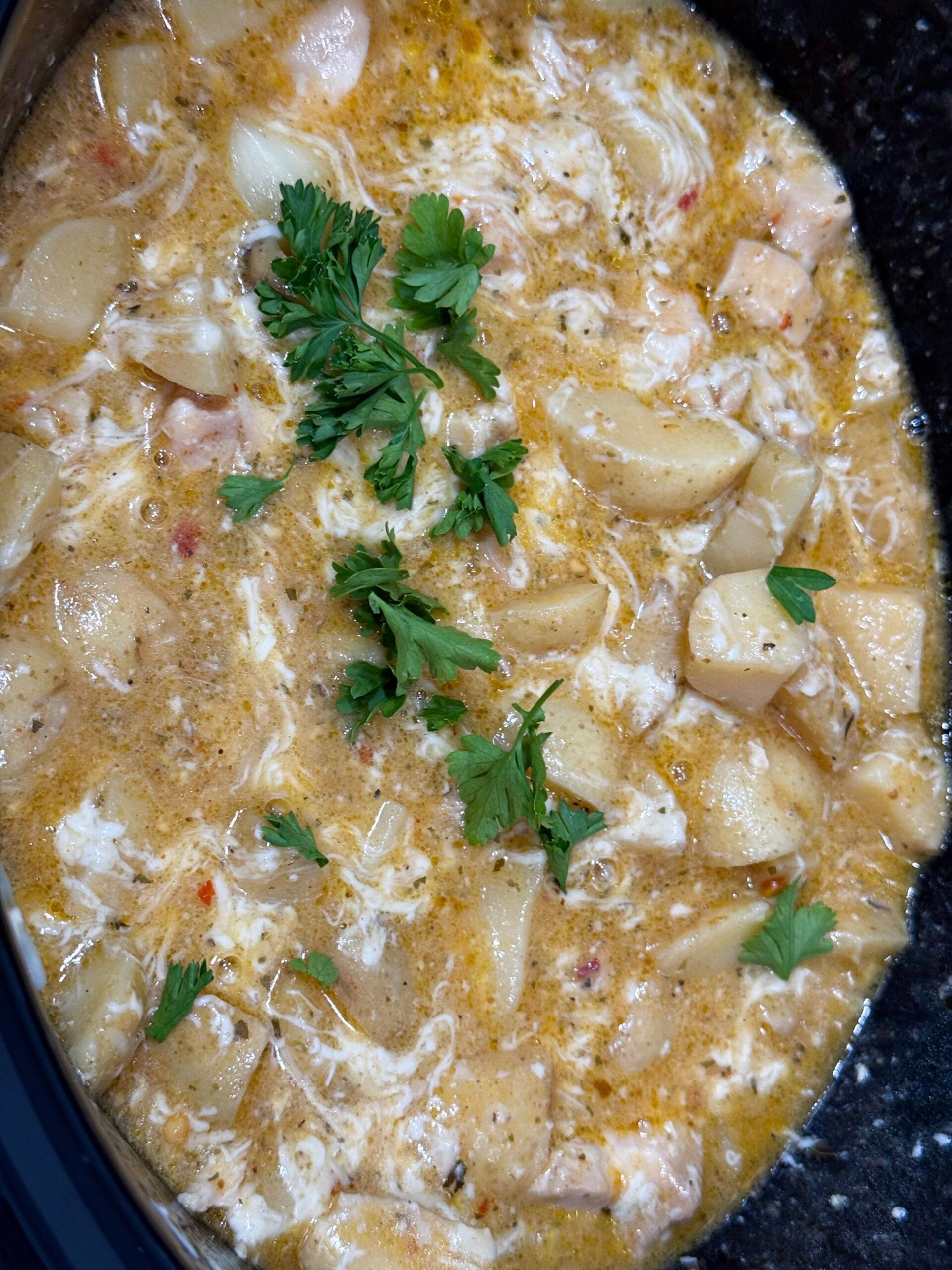 creamy parmesan sauce with cooked chicken and fresh parsley