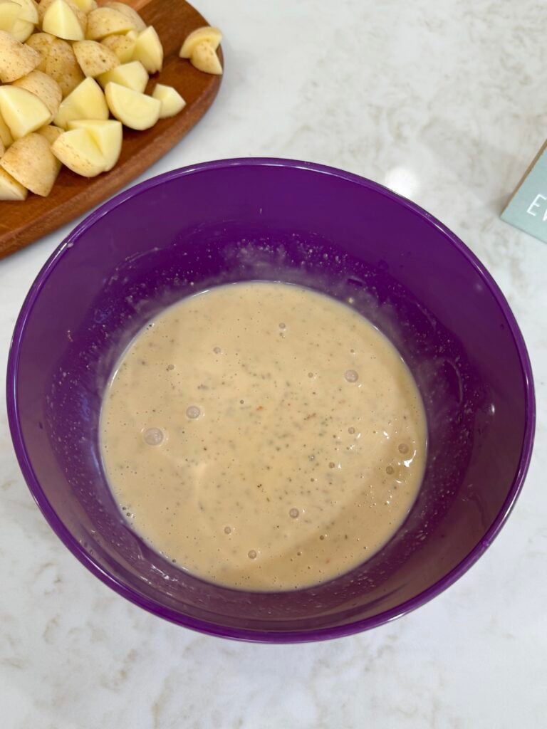 Parmesan mixture in a purple bowl on a white counter