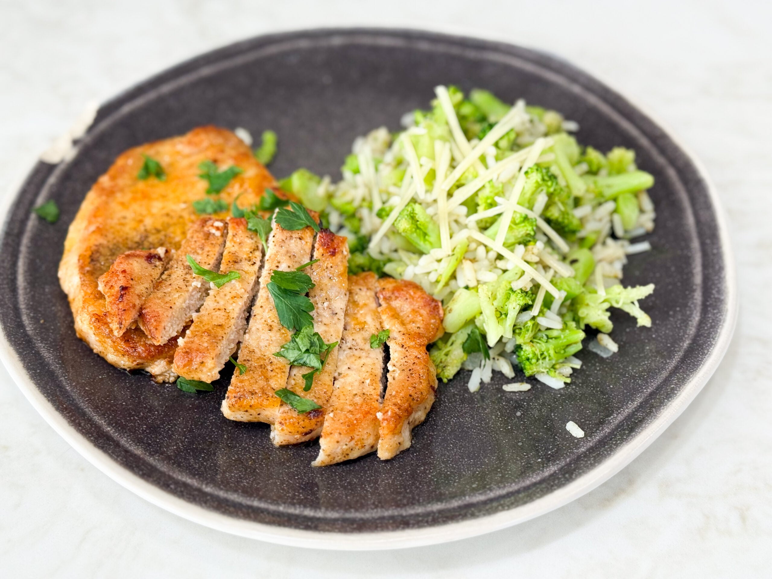 Crispy golden pan-fried pork chops in a skillet.