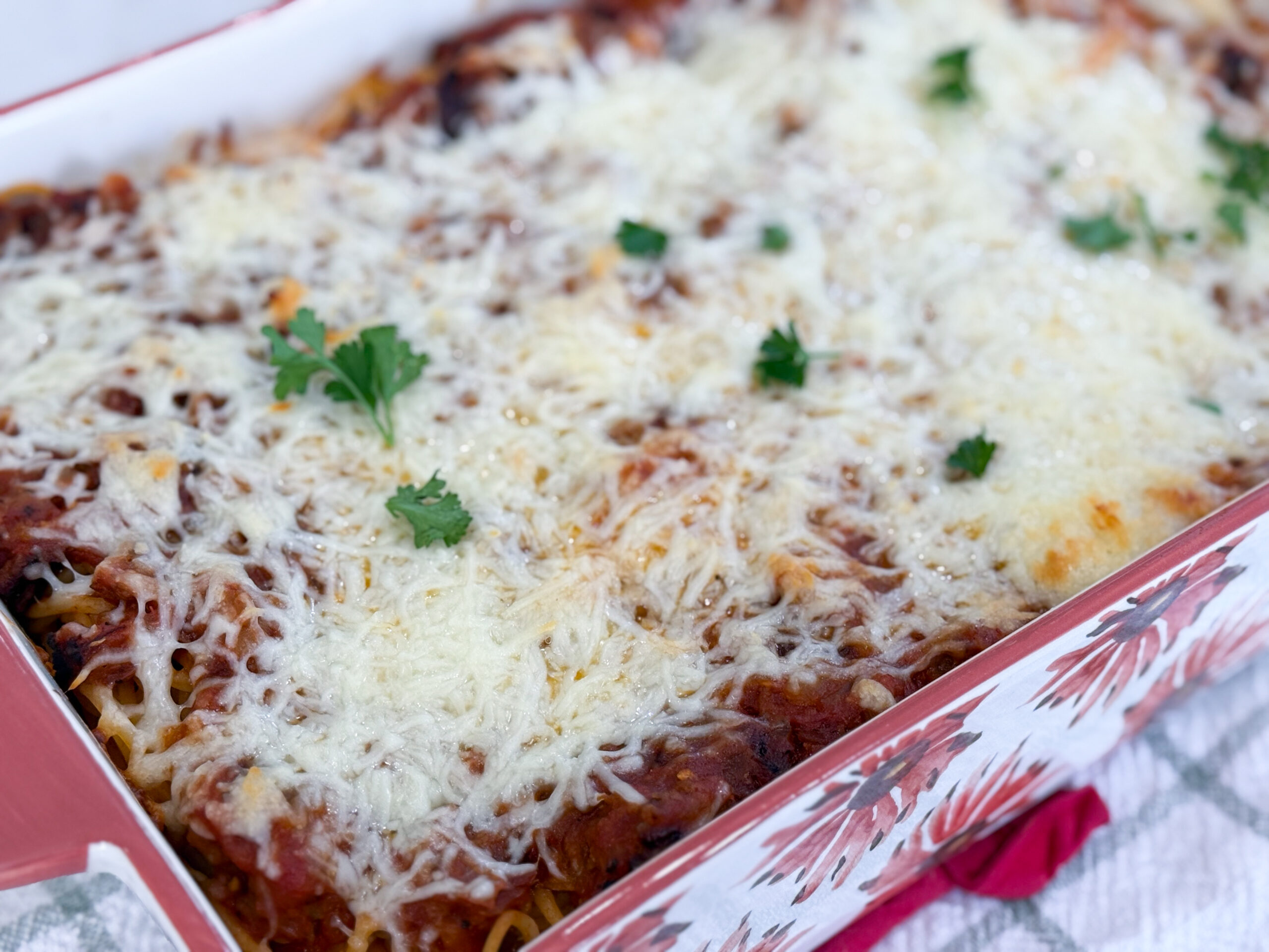 Million Dollar Spaghetti baked in a casserole dish with golden melted cheese on top.