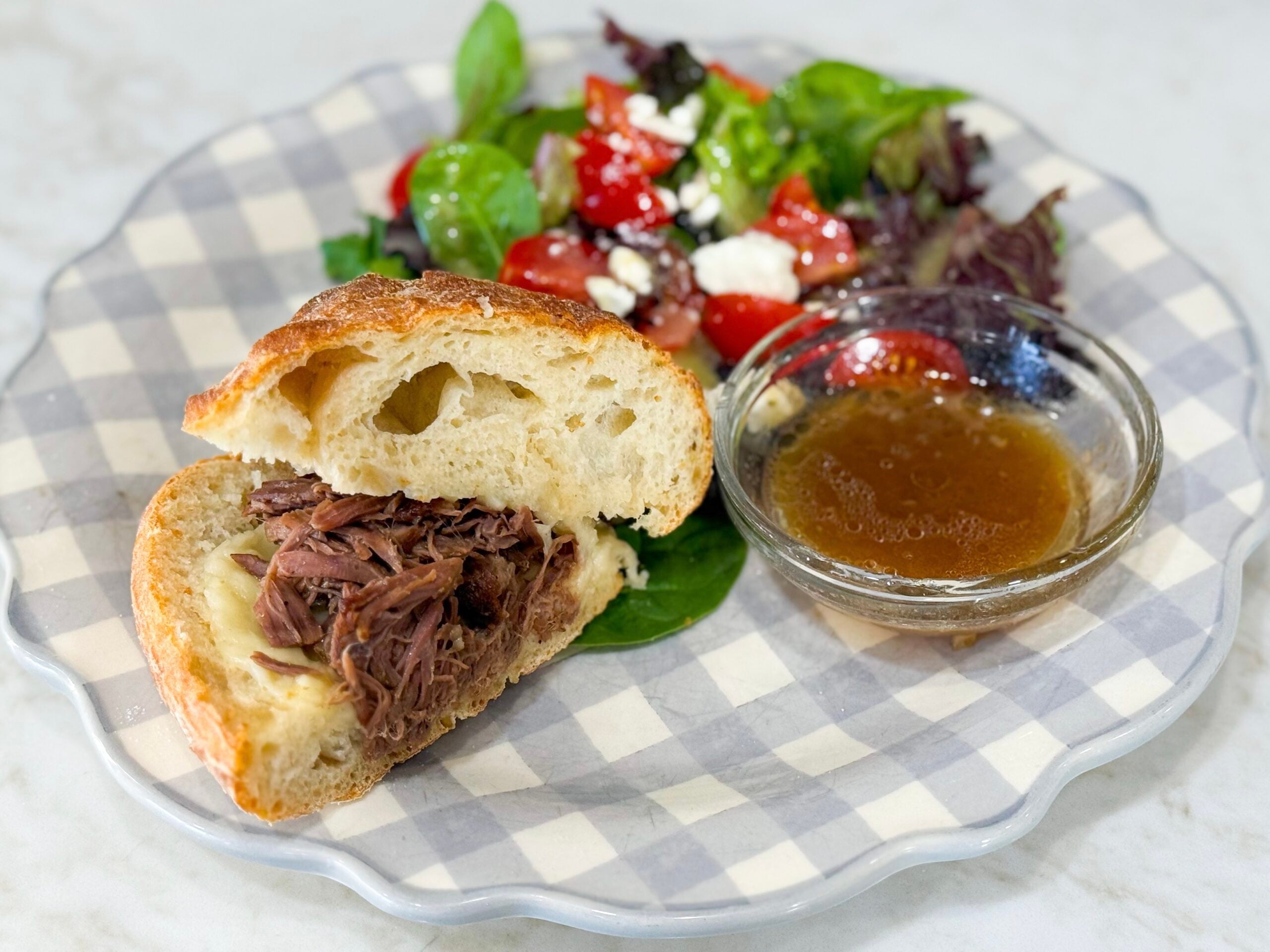 Pulled beef sandwiches with provolone cheese on soft buns.