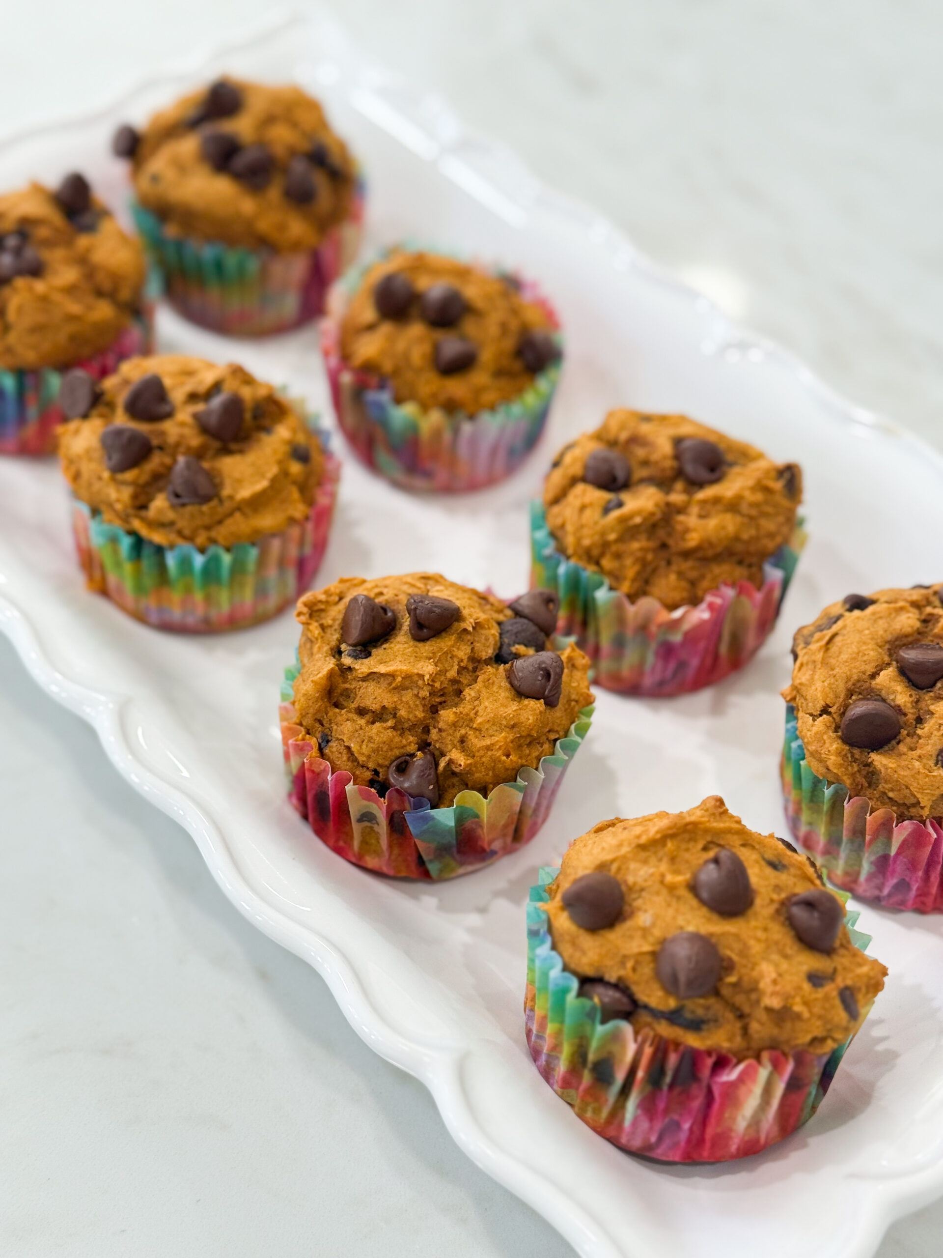 Pumpkin chocolate chip muffins on a cooling rack.