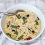 Bowl of creamy Slow Cooker Marry Me Chicken Soup with pasta, spinach, and sun-dried tomatoes