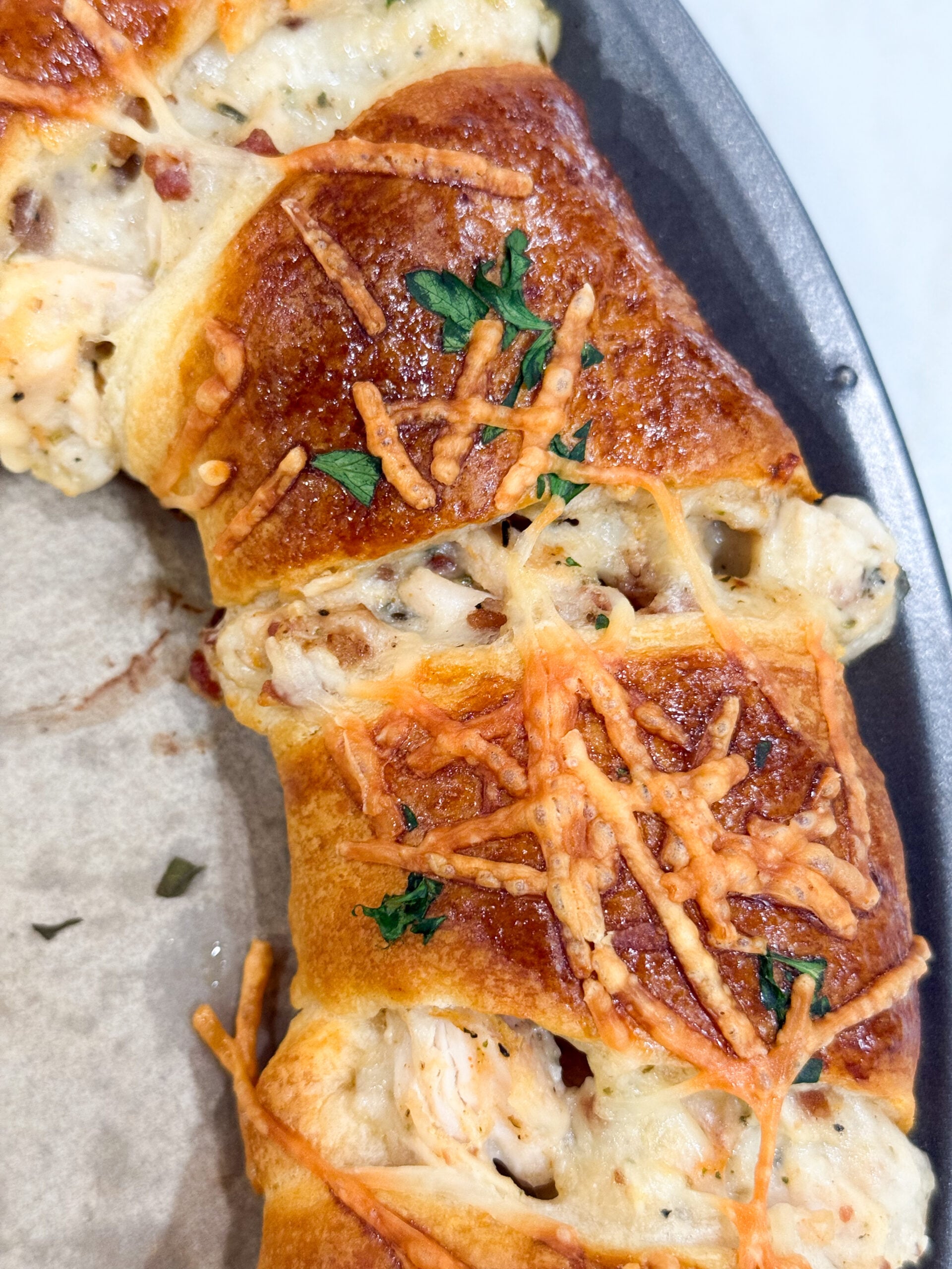 Golden crescent ring filled with chicken, bacon, and Alfredo sauce