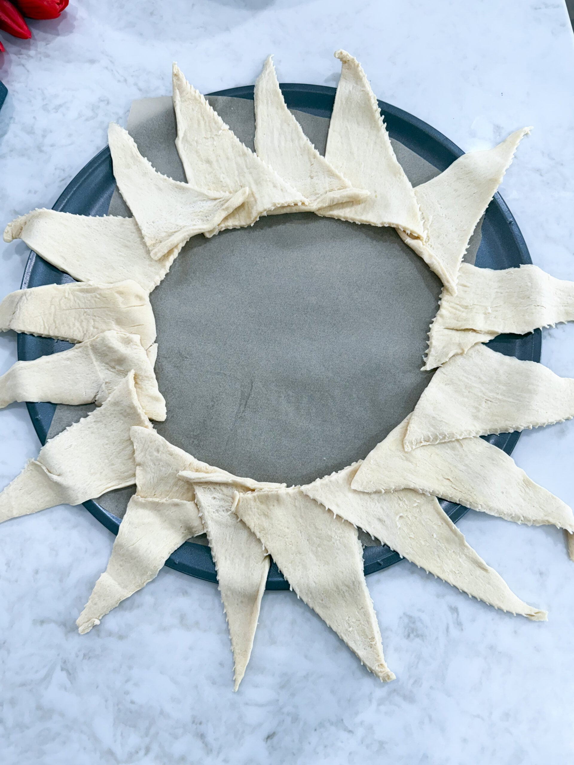Adding chicken Alfredo filling onto crescent ring base
