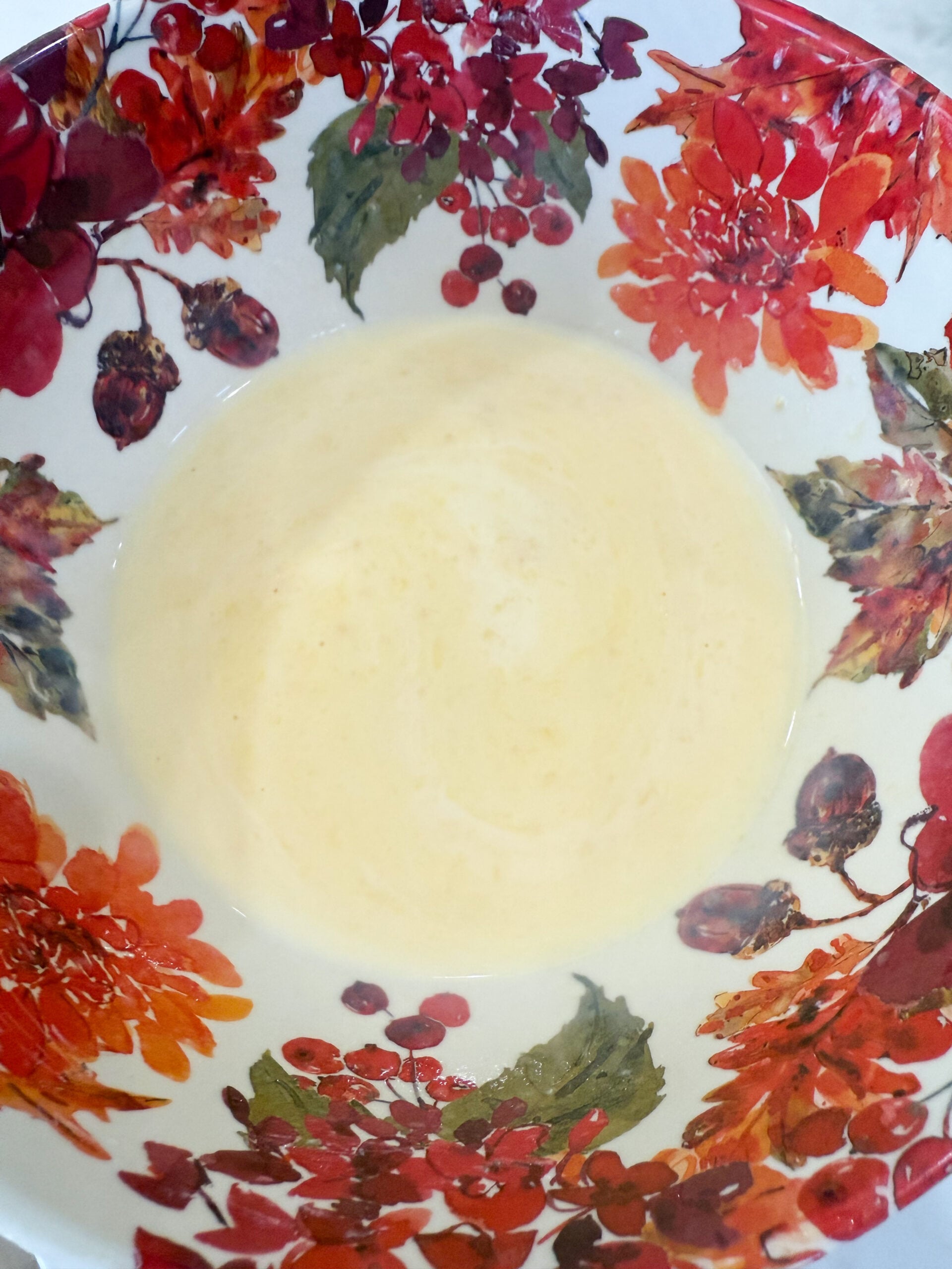 Chicken soup and milk wisked together in a bowl