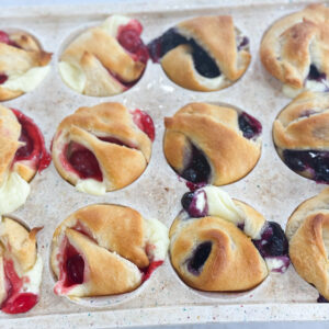 Golden mini cheesecake pies topped with blueberry filling