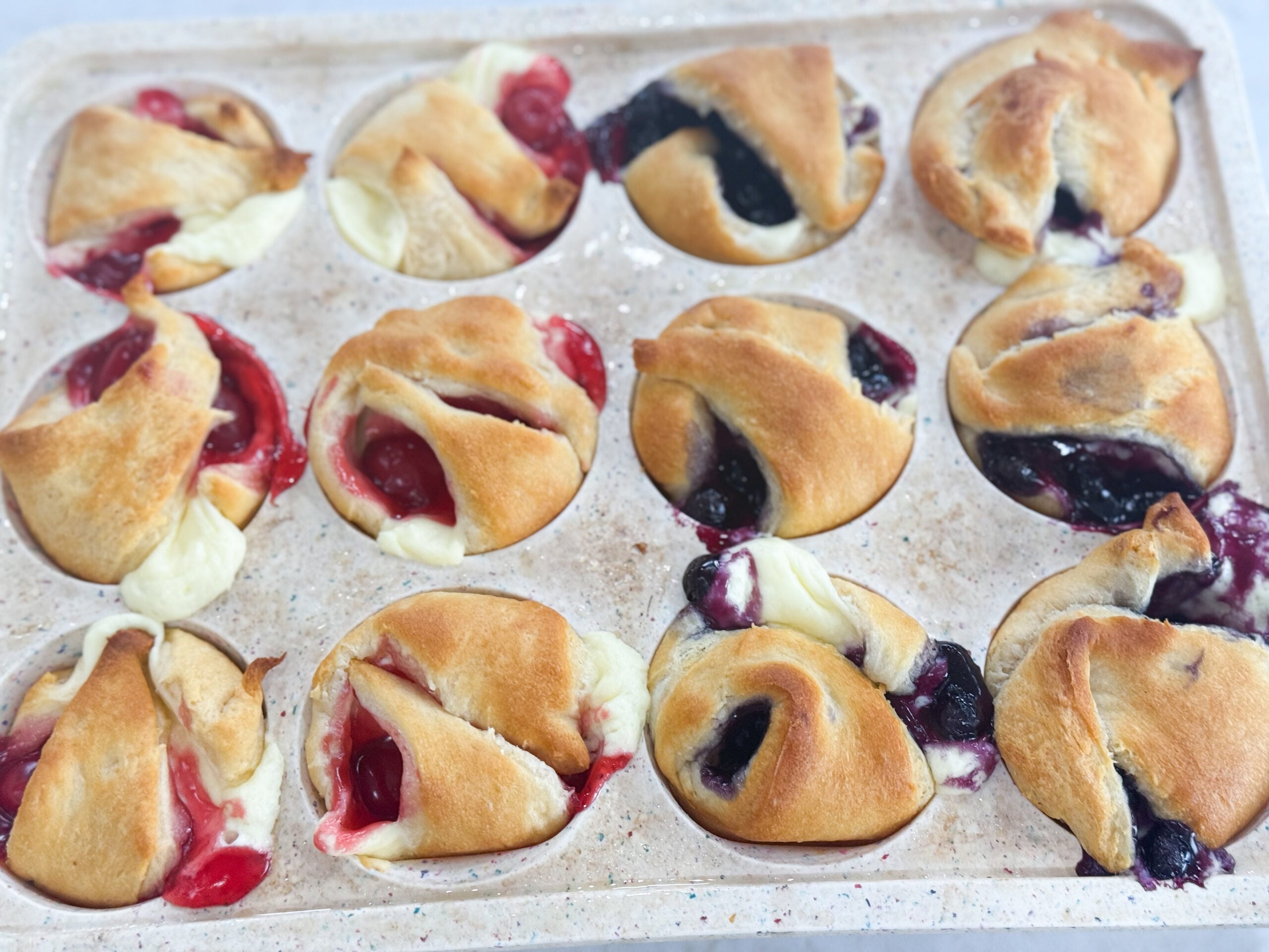 Golden mini cheesecake pies topped with blueberry filling