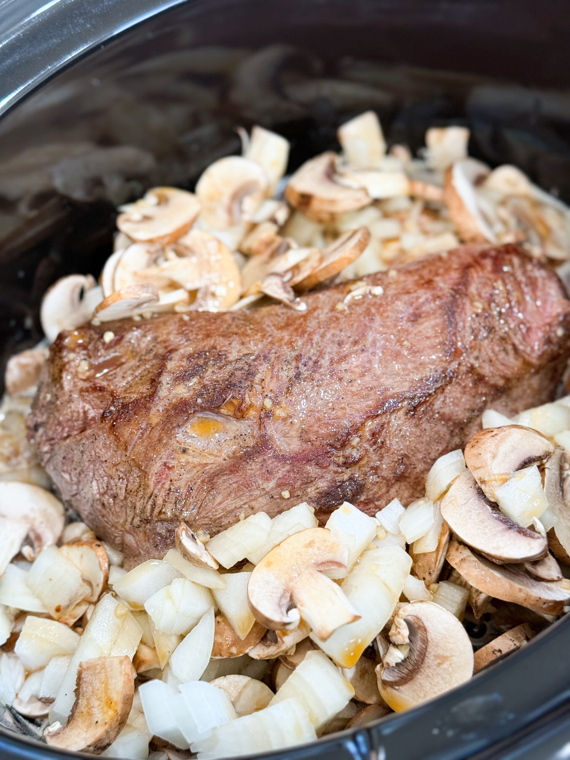 Beef, mushrooms, and onions in slow cooker