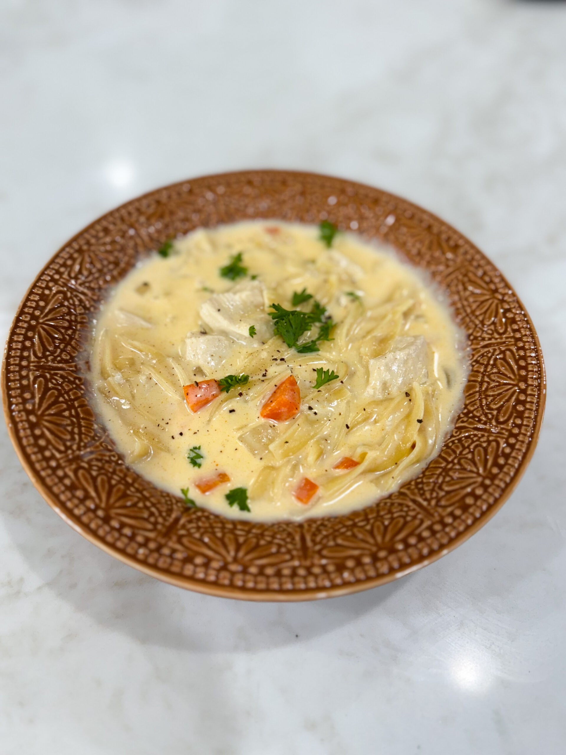 creamy chicken noodle soup served in a bowl