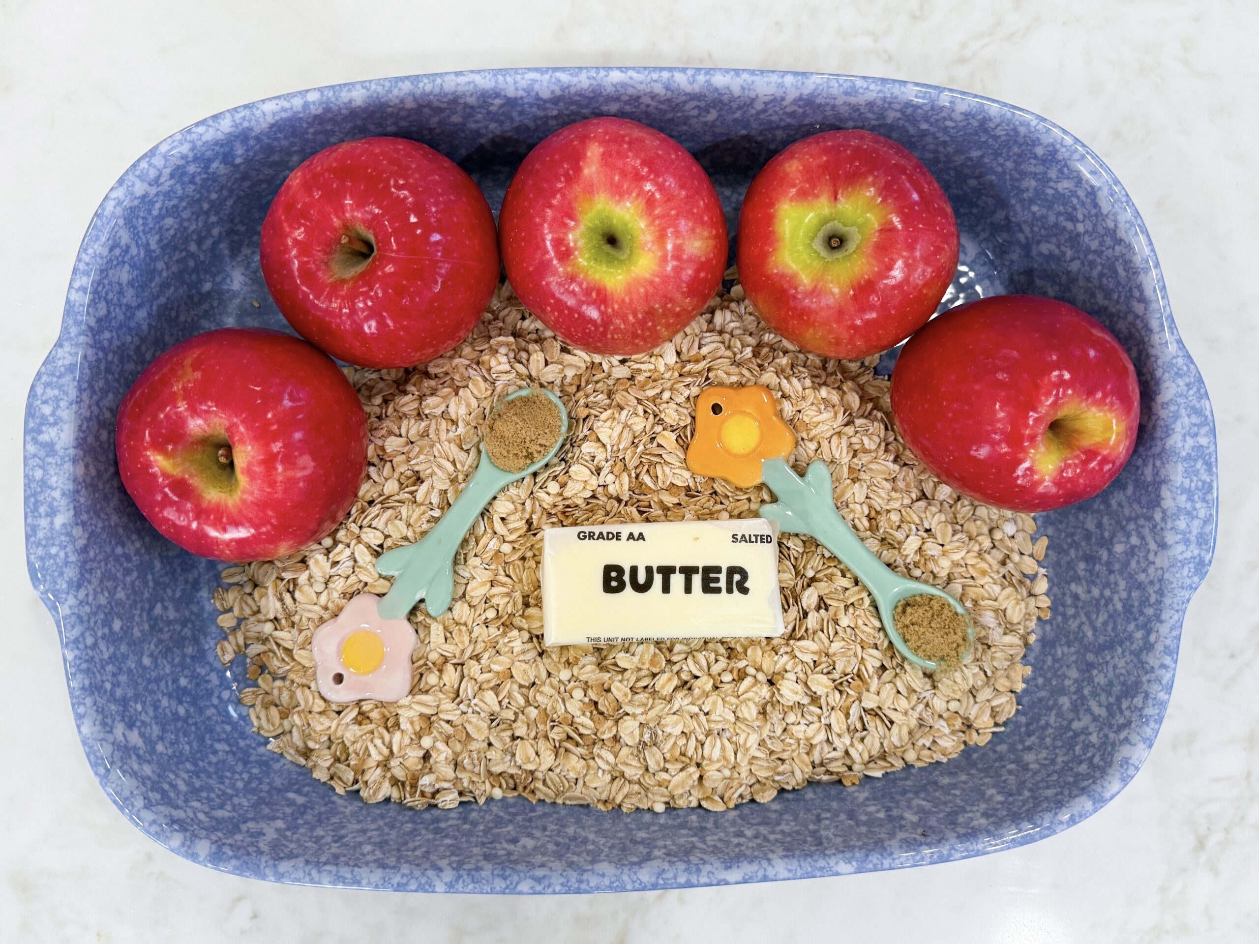 Ingredients for Grandma’s Old Fashioned Apple Crisp arranged in a pan