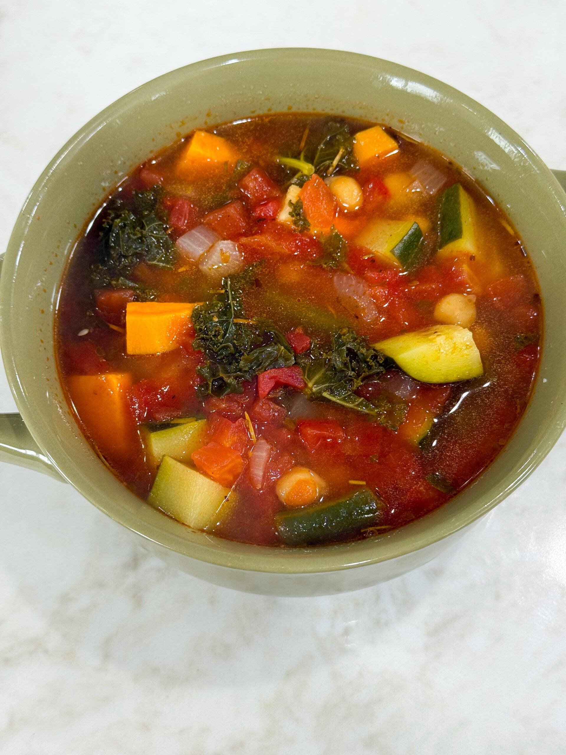 hearty vegetable soup with sweet potatoes, carrots, chickpeas, and kale