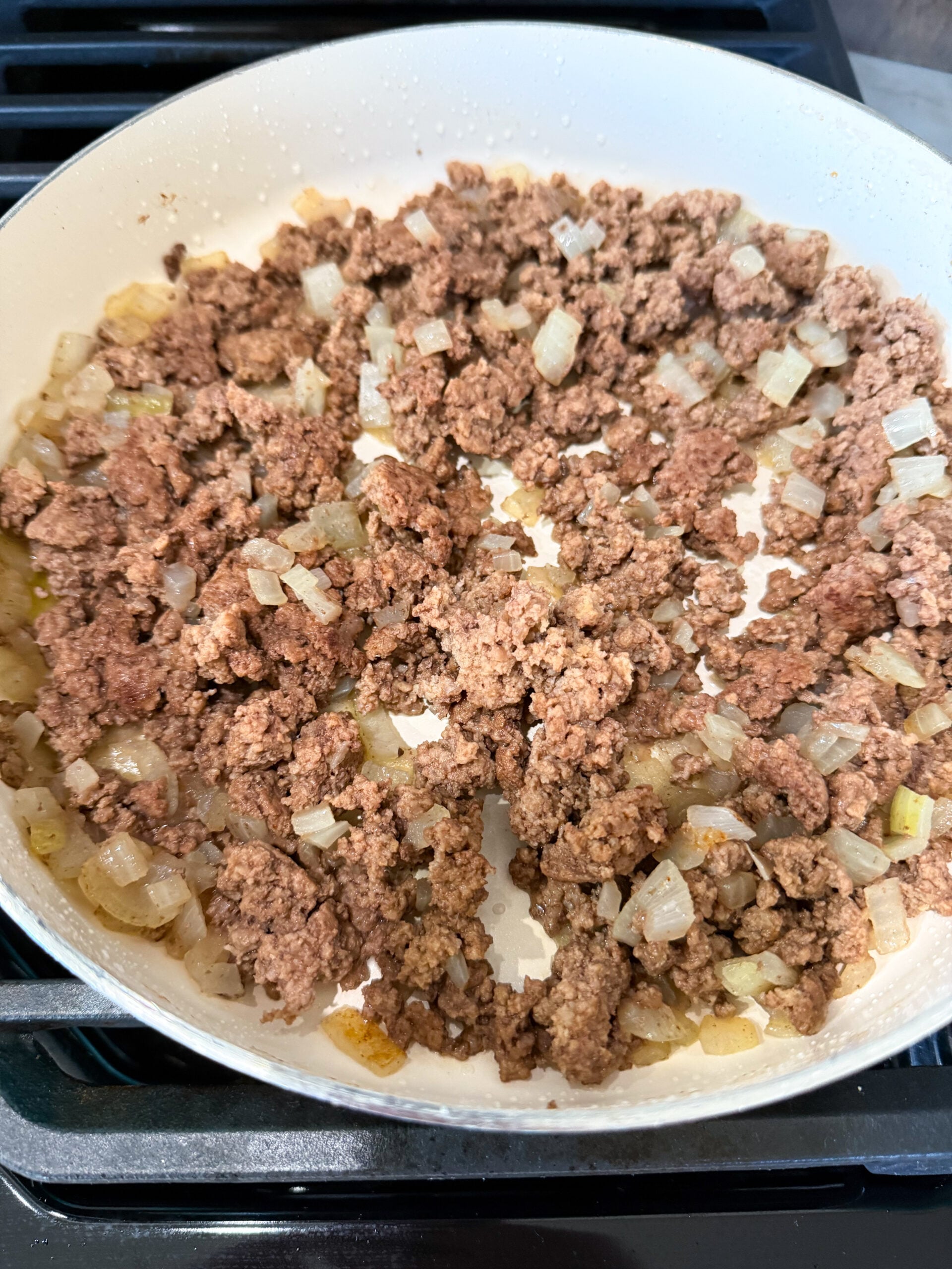 browned ground beef and onions in a skillet