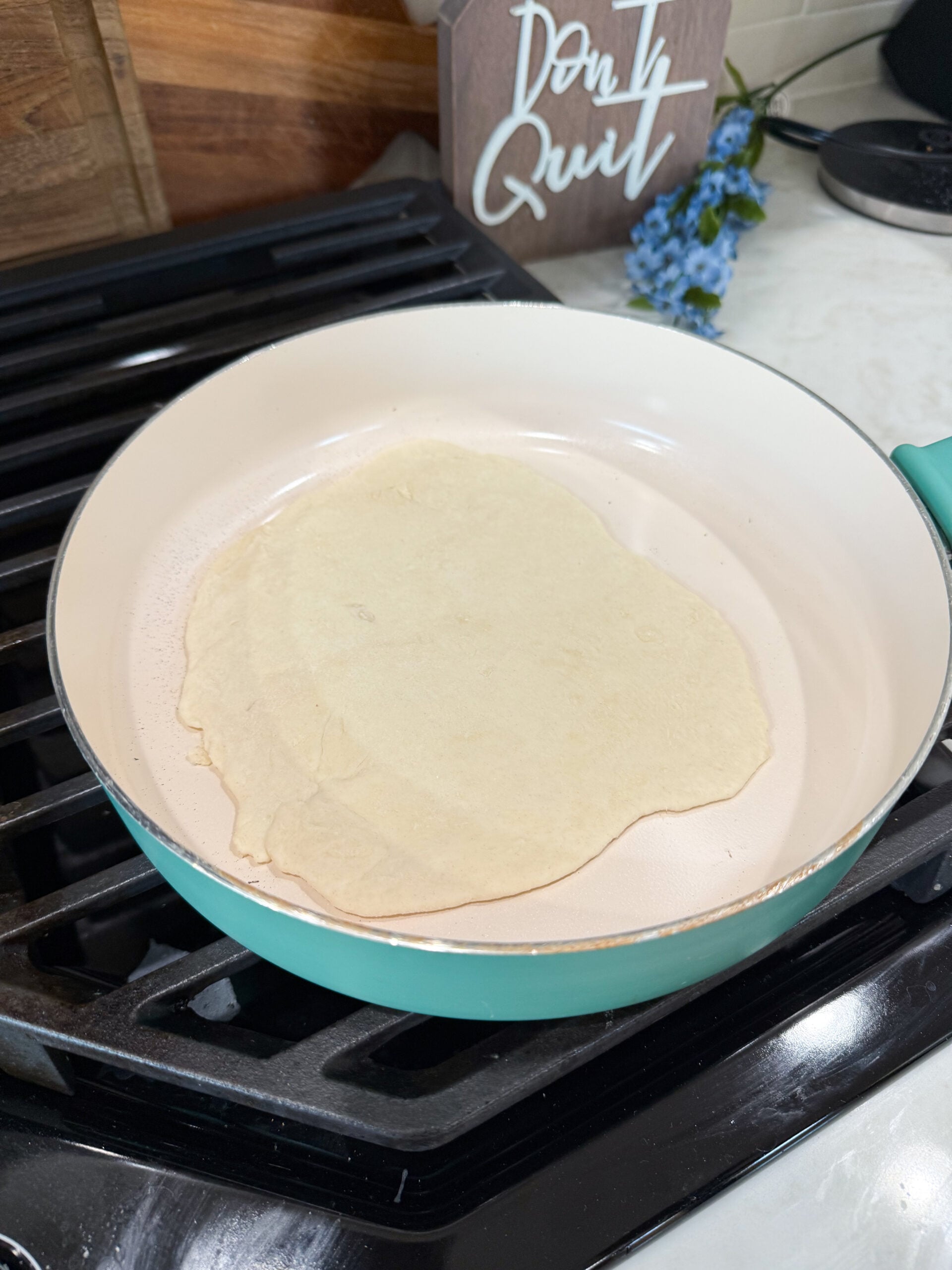 naan bread cooking in a skillet