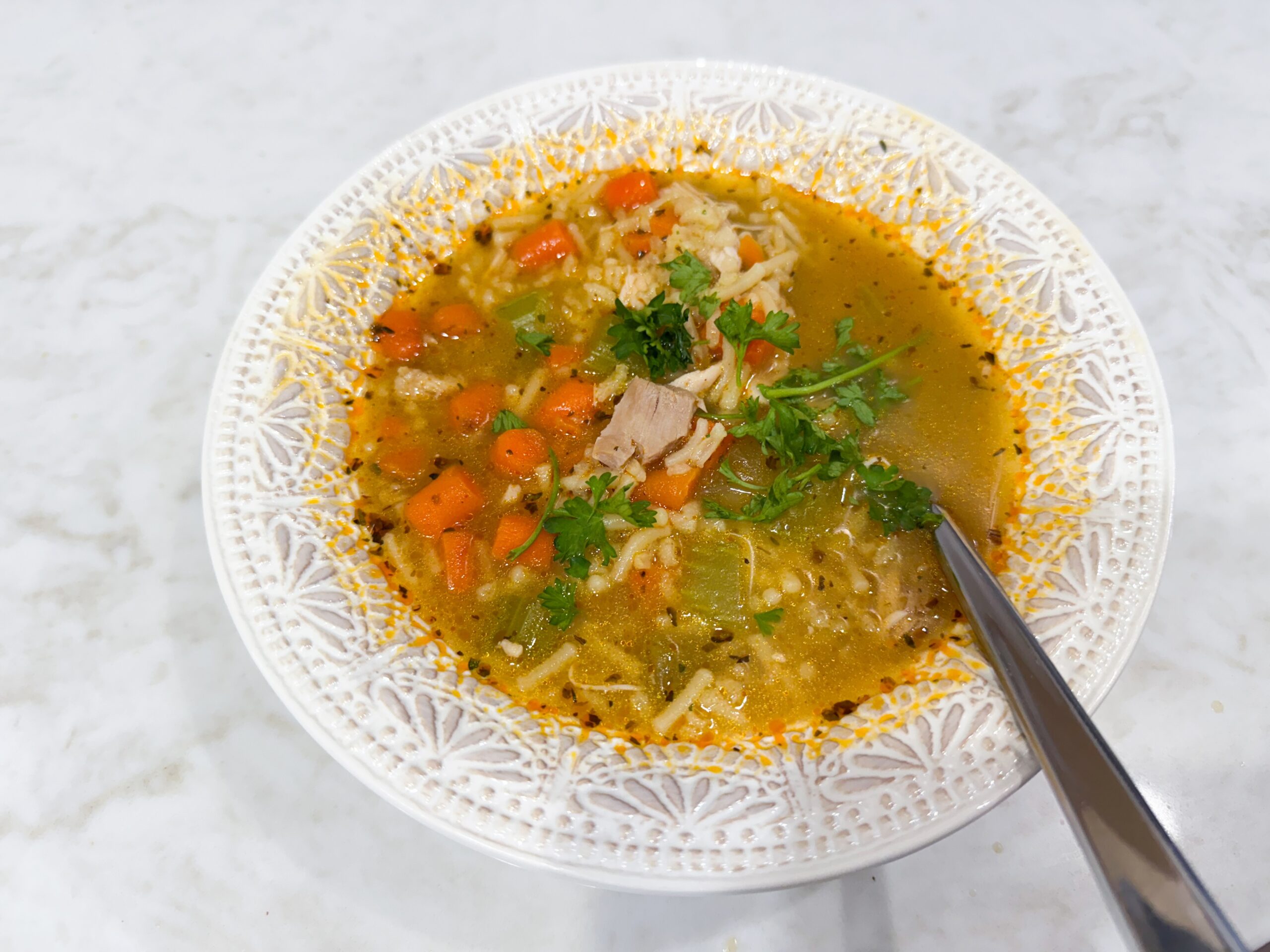Chicken and rice soup made with Rice-A-Roni, carrots, celery, and shredded chicken.